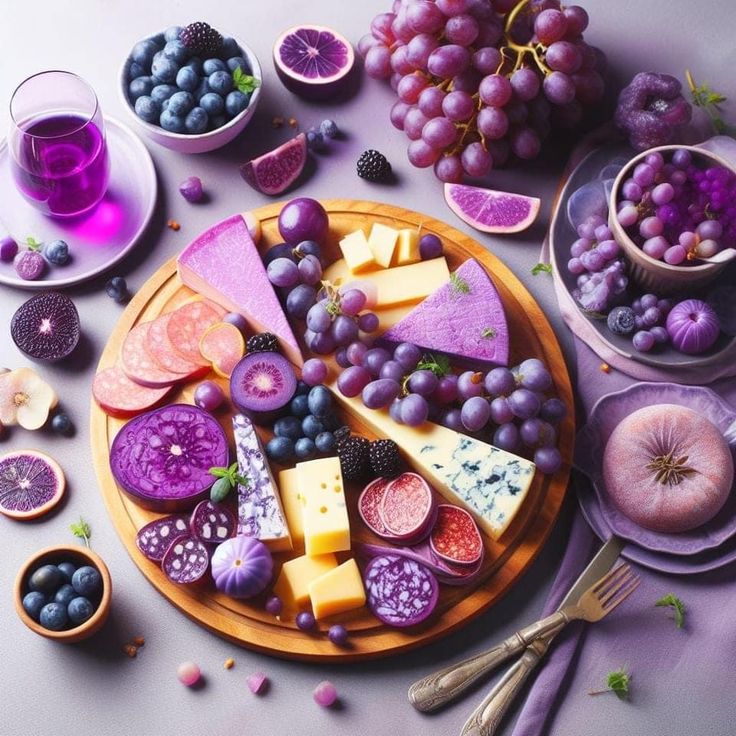 a plate full of different types of cheese and fruit