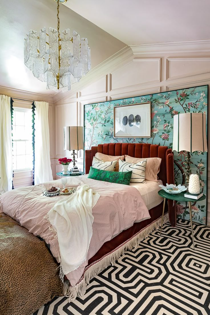 a bedroom with a bed, chandelier and rugs on the floor in front of a window