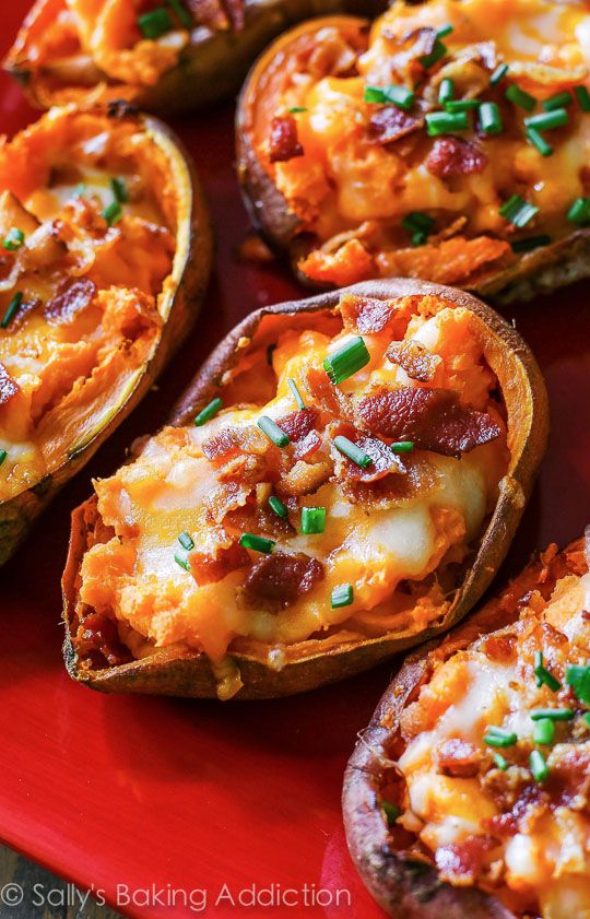 baked potato skins with cheese and bacon on a red plate, ready to be eaten