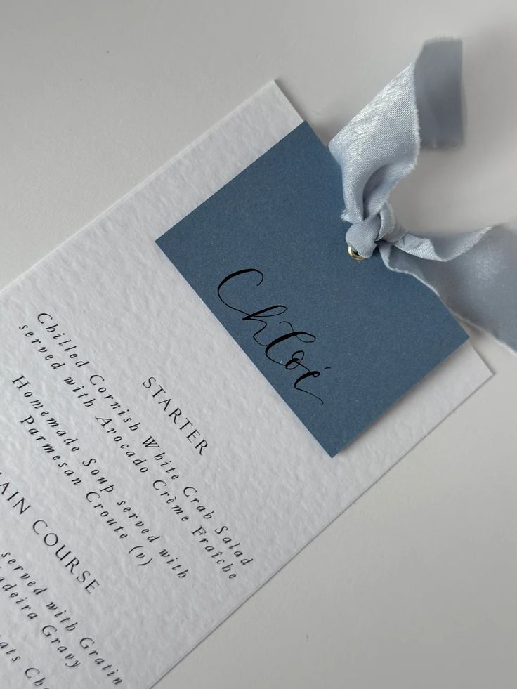 a close up of a piece of paper with a ribbon attached to the back of it