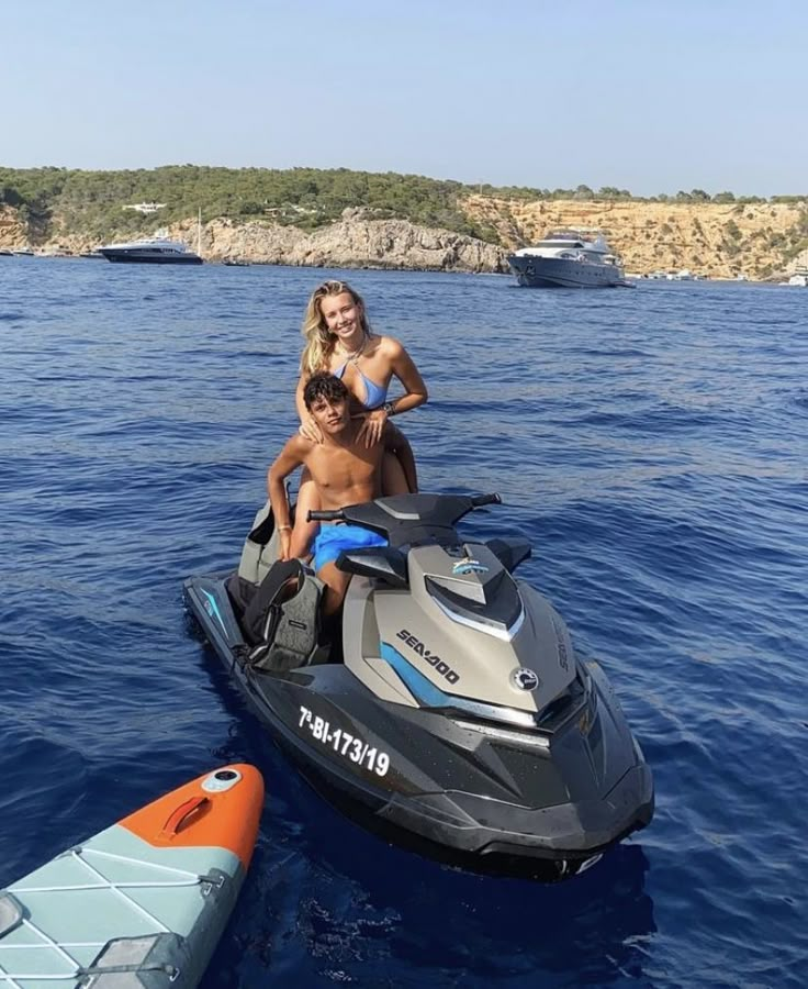 two people on a jet ski in the water