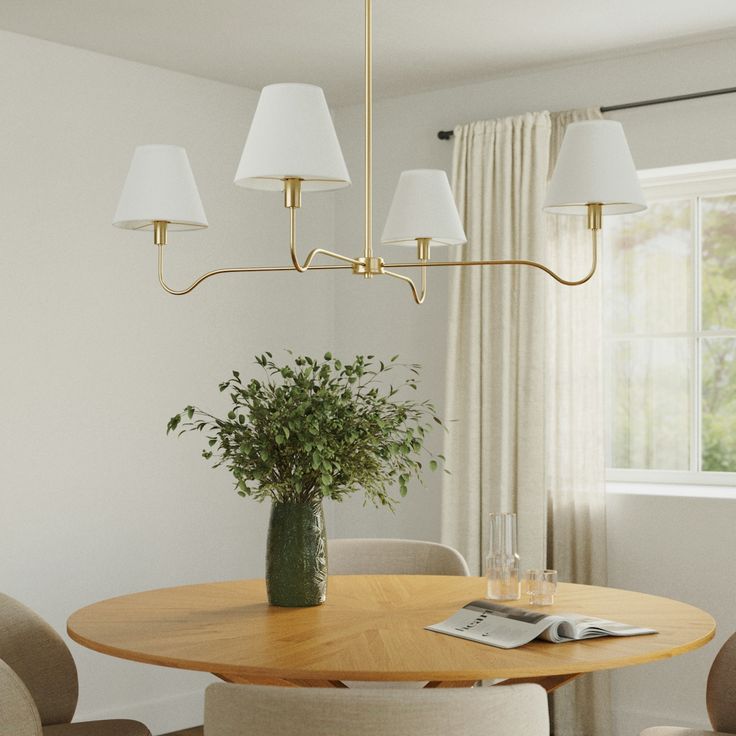 a dining room table with four chairs and a vase on the table in front of it