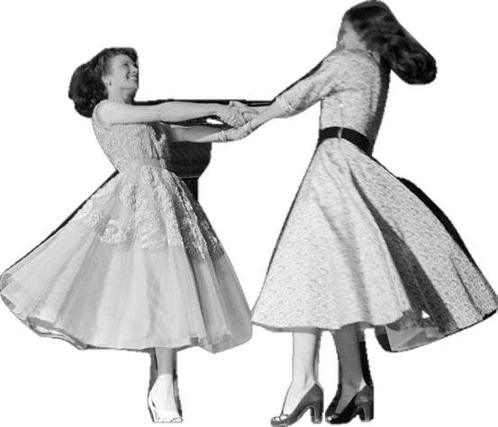 two women in dresses and high heels are holding each other's hands as they dance