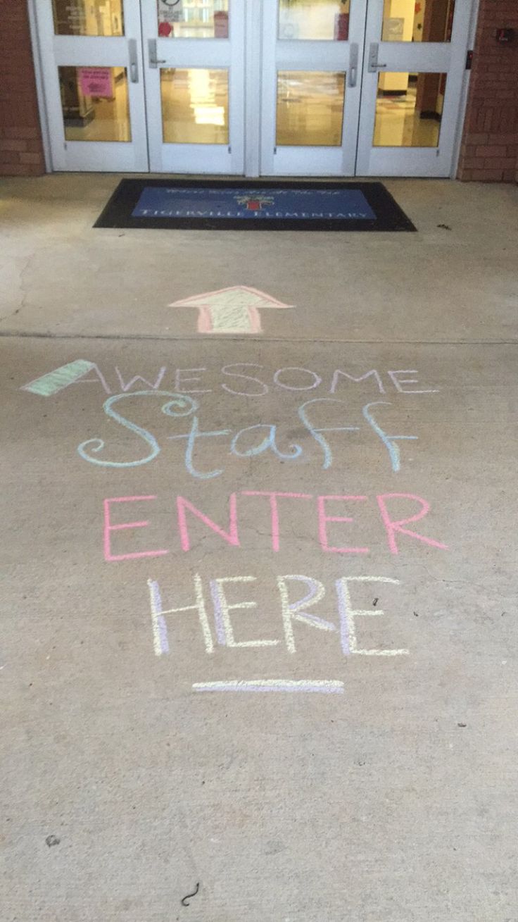 the welcome sign is written in chalk on the sidewalk