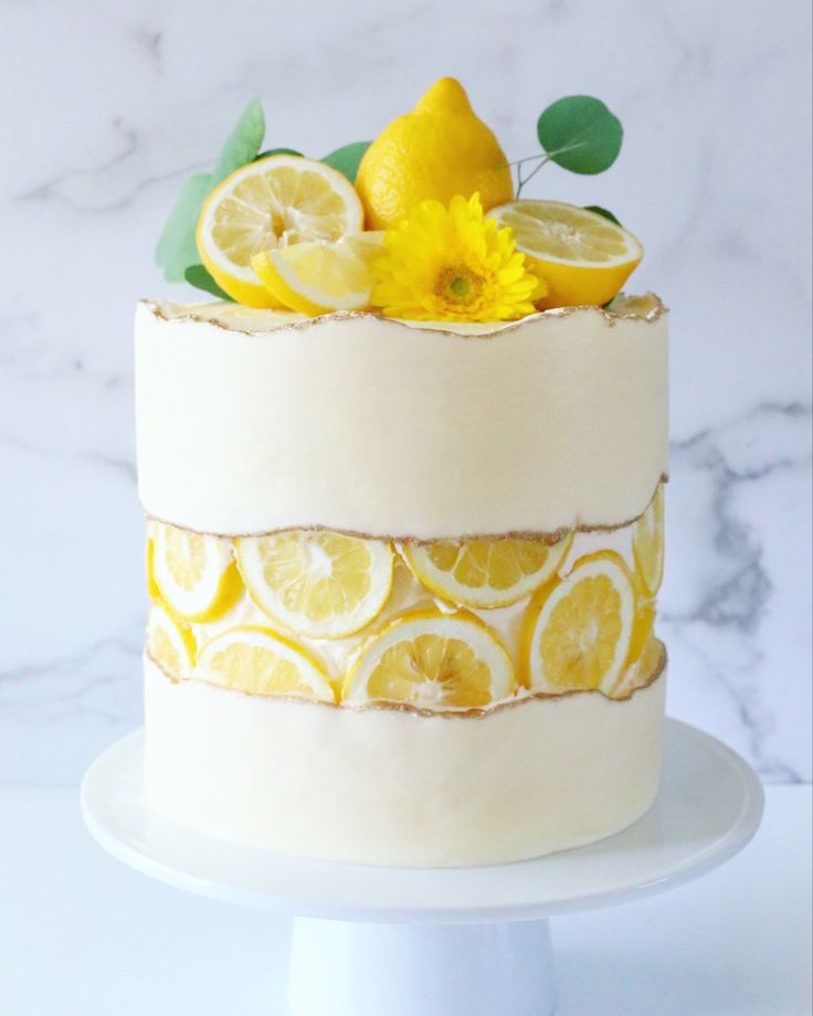 a white cake with lemons and flowers on top