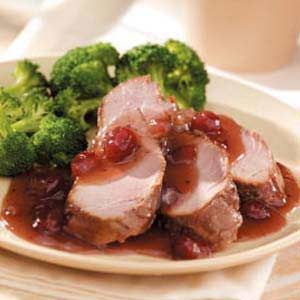 some meat and broccoli on a white plate with sauce in the middle for garnish