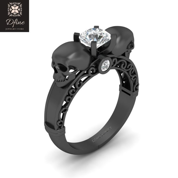 a black diamond skull ring with skulls on it