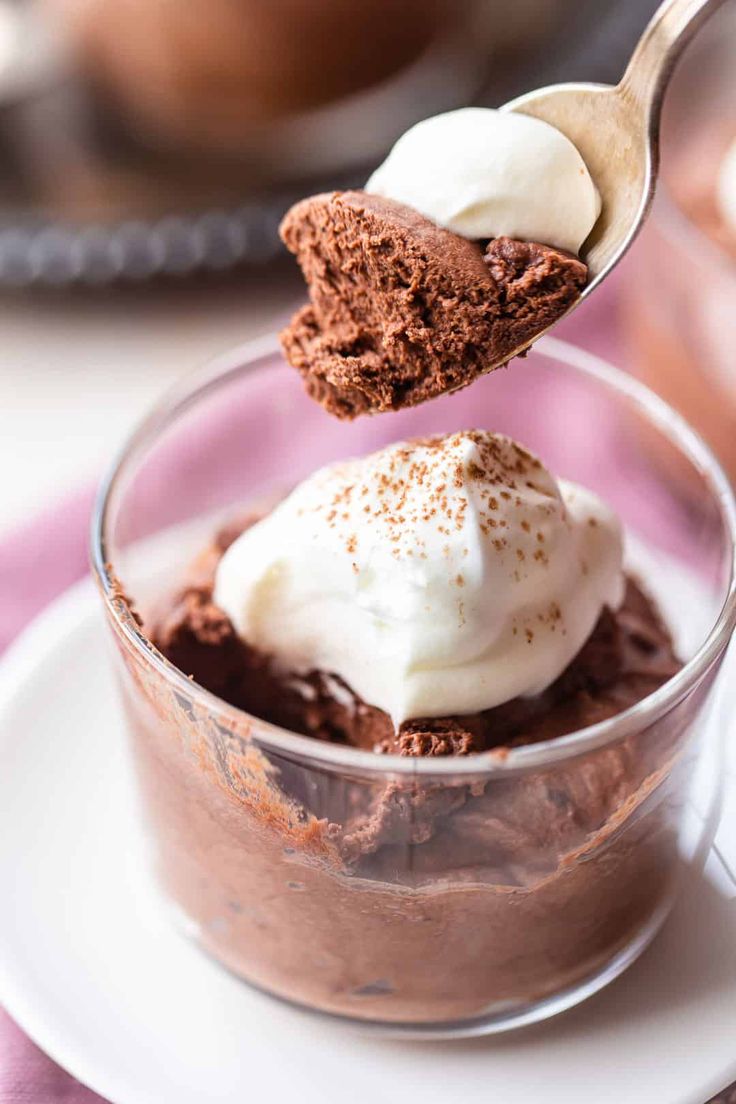 a spoonful of chocolate pudding with whipped cream