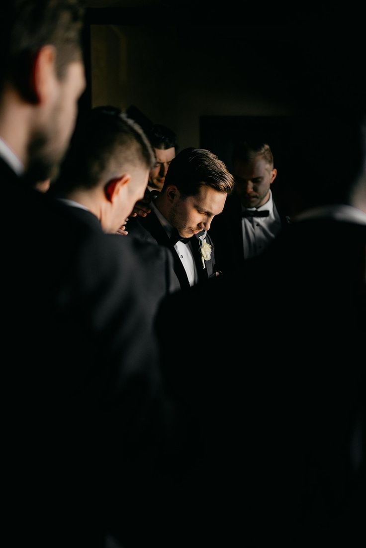 a group of men in tuxedos standing next to each other