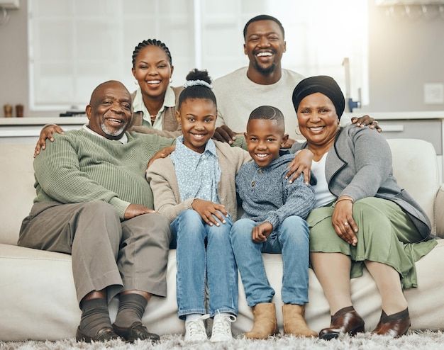 a family sitting on a couch smiling at the camera