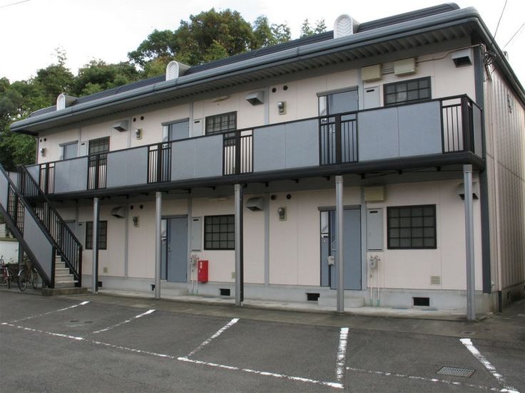 an apartment building with balconies on the second floor