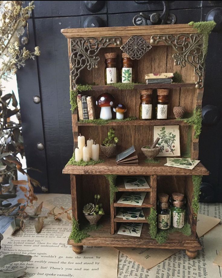 an old wooden shelf with moss growing on it's sides and candles in the middle