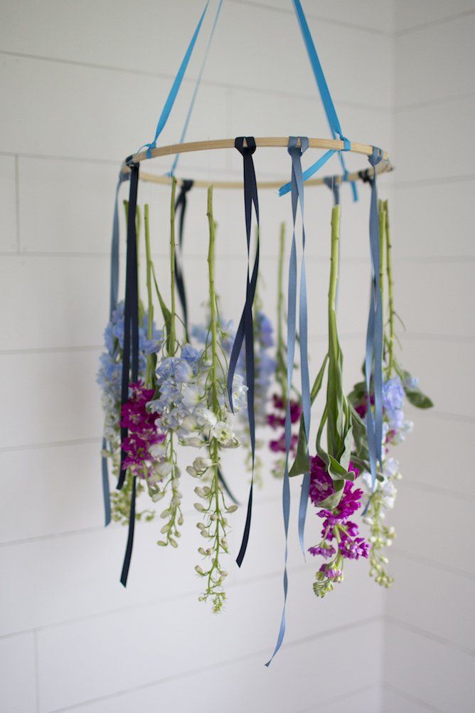 a mobile with flowers hanging from it's sides