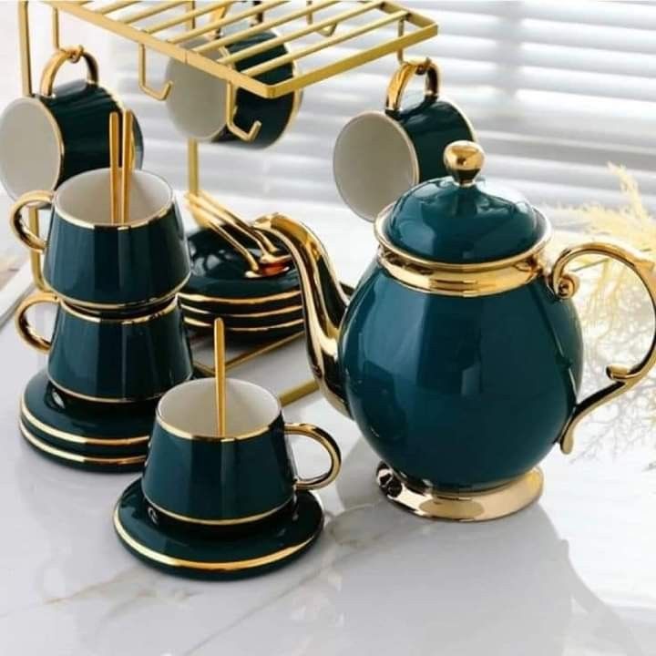 a tea set with cups and saucers on a table