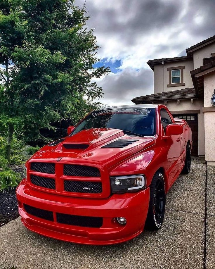 a red truck parked in front of a house