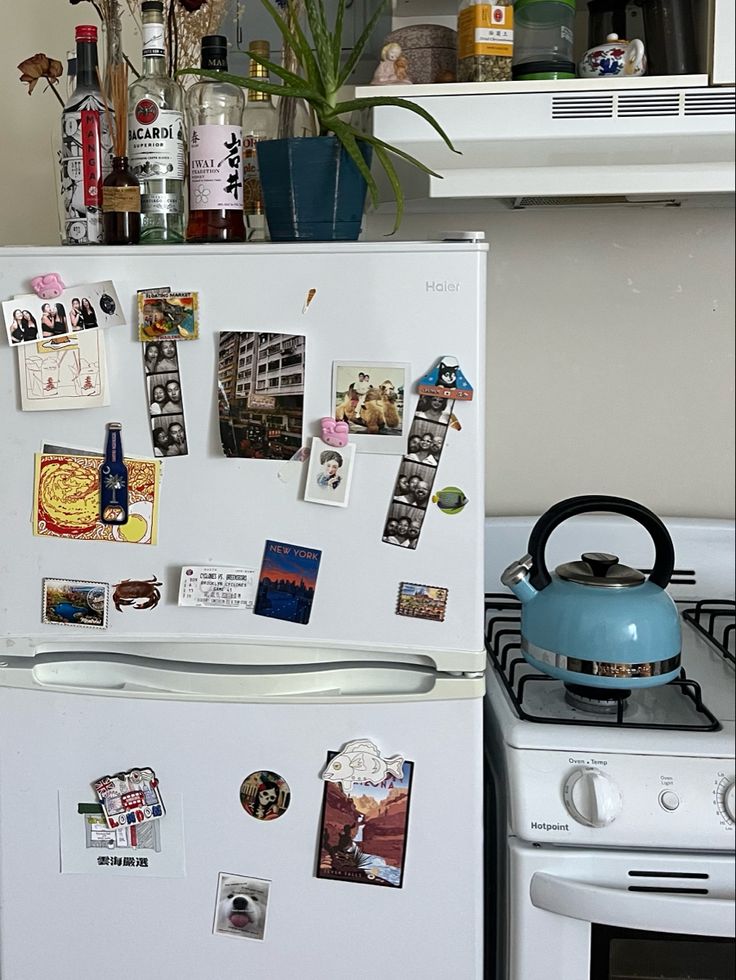 a white refrigerator freezer sitting next to a stove top oven