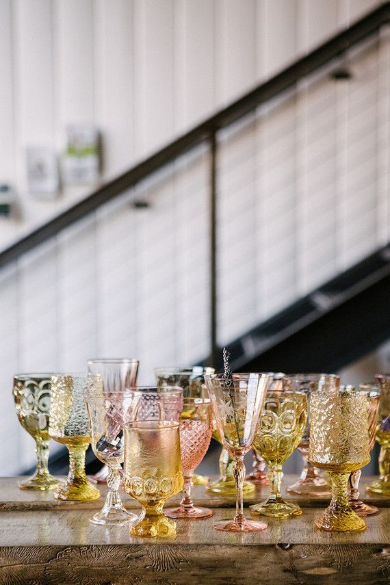 many wine glasses are lined up on a table