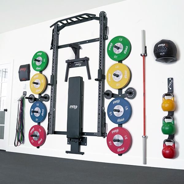 a wall mounted gym equipment with different colored plates and barbells