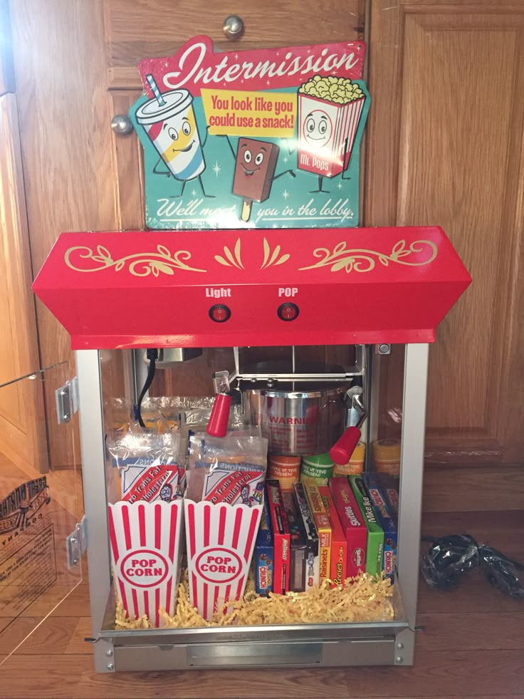 an old fashioned popcorn vending machine with lots of food in it's trays