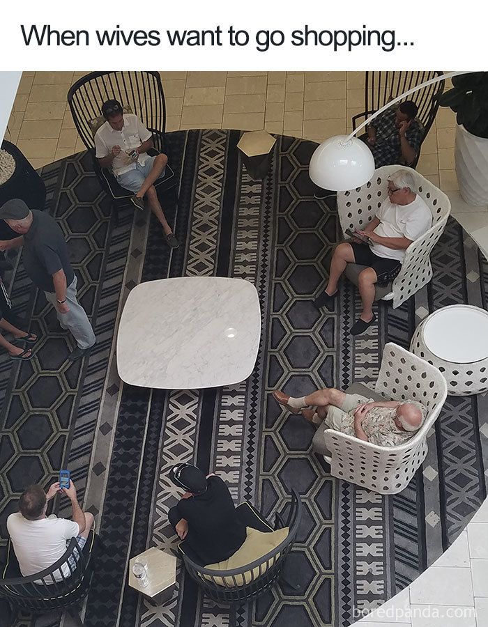 several people sitting at tables and chairs in a room with black and white patterned flooring