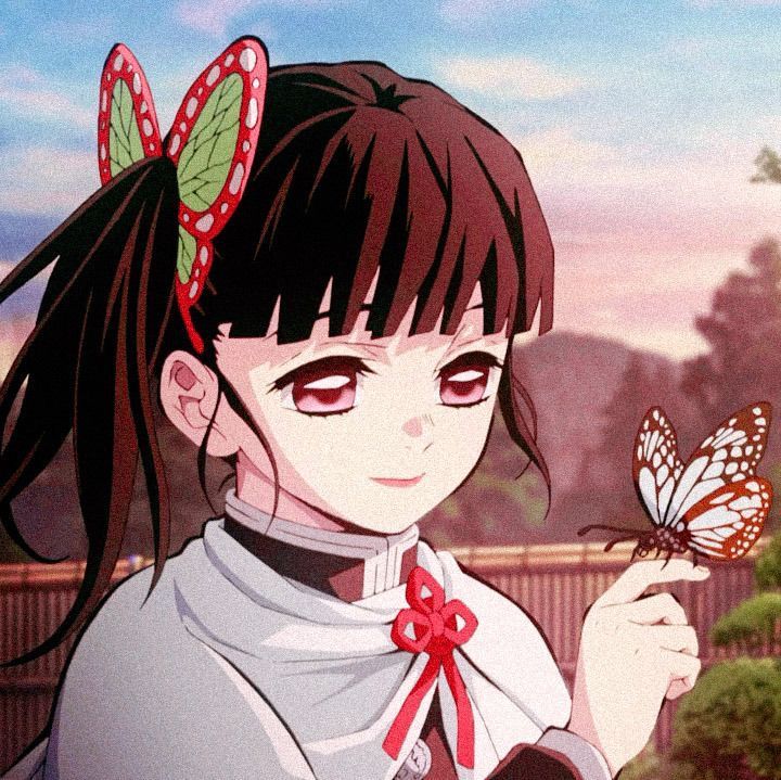 a girl holding a butterfly in her hand