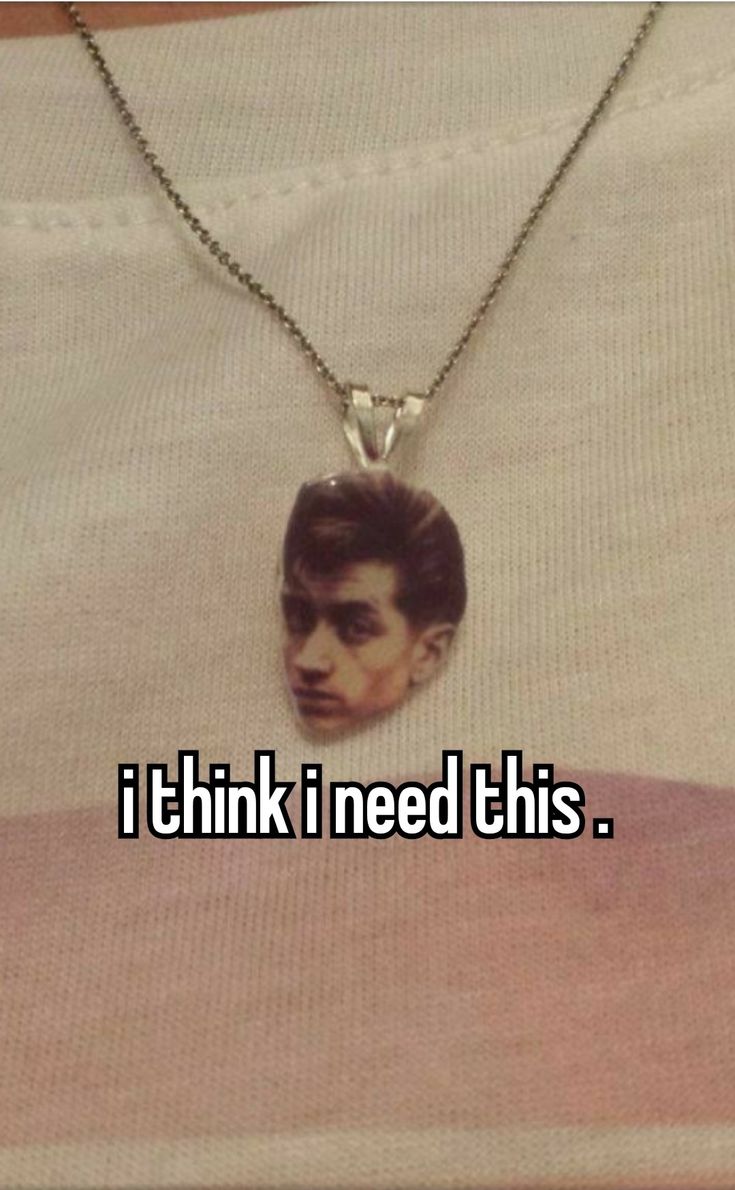 a man wearing a necklace with the words i think i need this