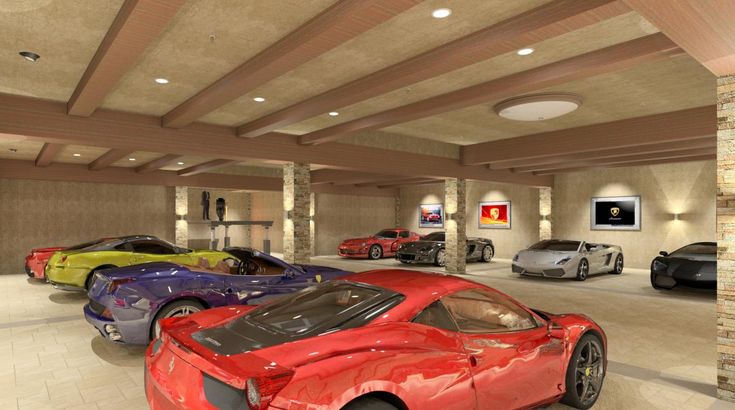 there are many different colored sports cars in this garage