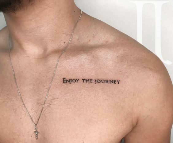 a man with a cross tattoo on his chest that says enjoy the journey written in black ink