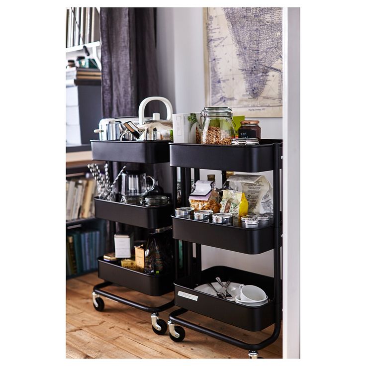 an image of a kitchen cart with food on the top and bottom shelves in it