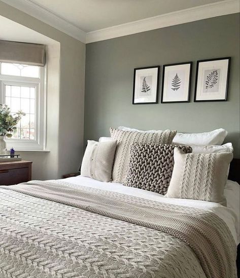 a bedroom with gray walls and white bedding