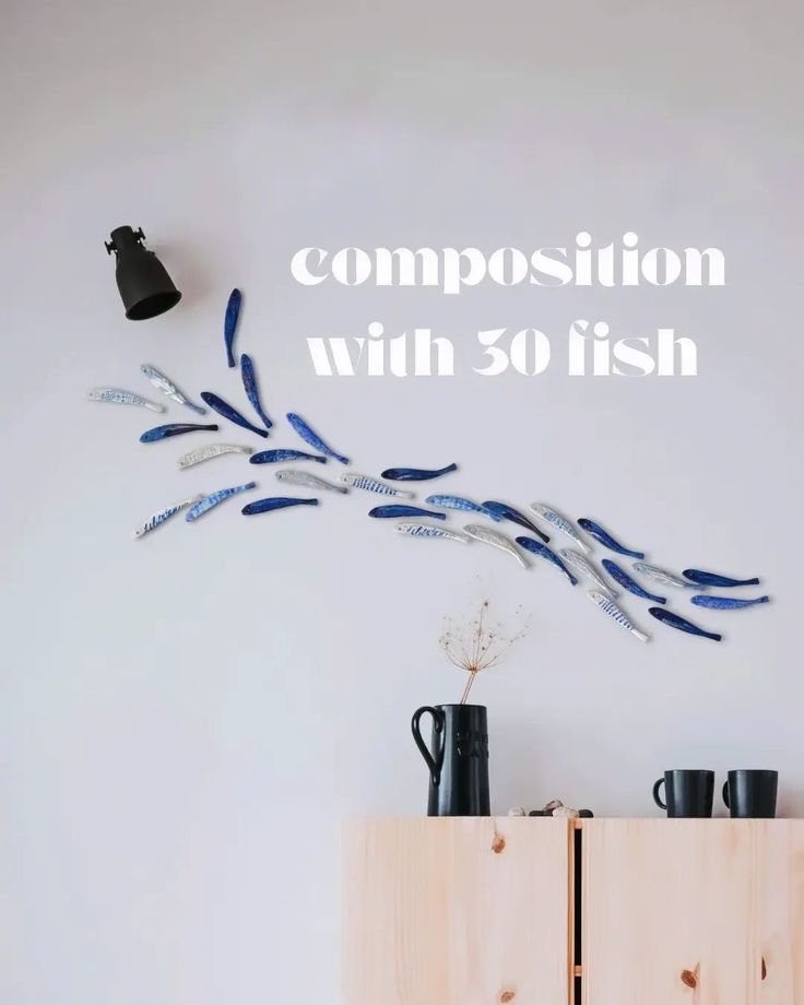 a wooden cabinet sitting next to a white wall with the words composition with 50 fish on it