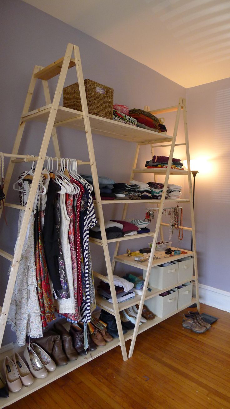 a ladder shelf with clothes and shoes on it