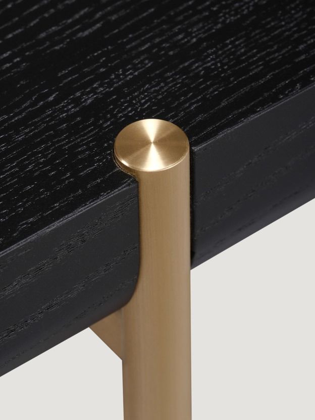 a black and gold table with a metal handle