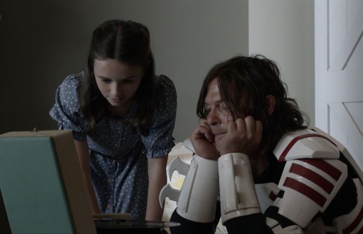 a man sitting in front of a laptop computer next to a woman