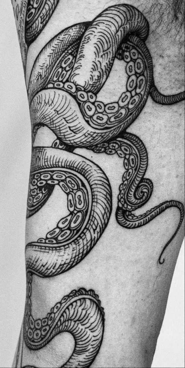 a man's arm with an intricate tattoo design on the side of his leg