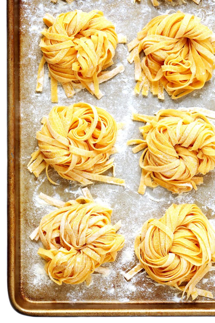 four uncooked pastas on a baking sheet ready to go into the oven