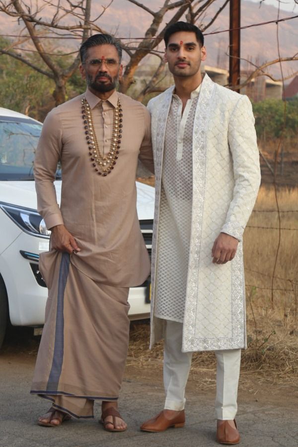 Cricketer KL Rahul and actor Athiya Shetty’s wedding has been one of the most anticipated celebrity shaadis of 2023. The nuptial that took place at actor and Athiya’s father Suniel Shetty’s Bungalow in Khandala was an intimate affair with no-phone policy being the norm for the guests. However, now the pictures from the wedding are out and we can’t keep calm. While we may need to wait some more for the pictures of the ‘couple of the moment’, we have dad and brother Shetty’s pictures out now and t Wedding Brothers Outfit, Wedding Outfits For Grooms Brother, Wedding Outfit For Bride's Brother, Bride Father Outfit Indian, Wedding Dress For Brother, Brides Brother Outfit Indian, Brother Wedding Dress For Men, Groom Brother Outfit Indian, Latest Sherwani Designs For Groom