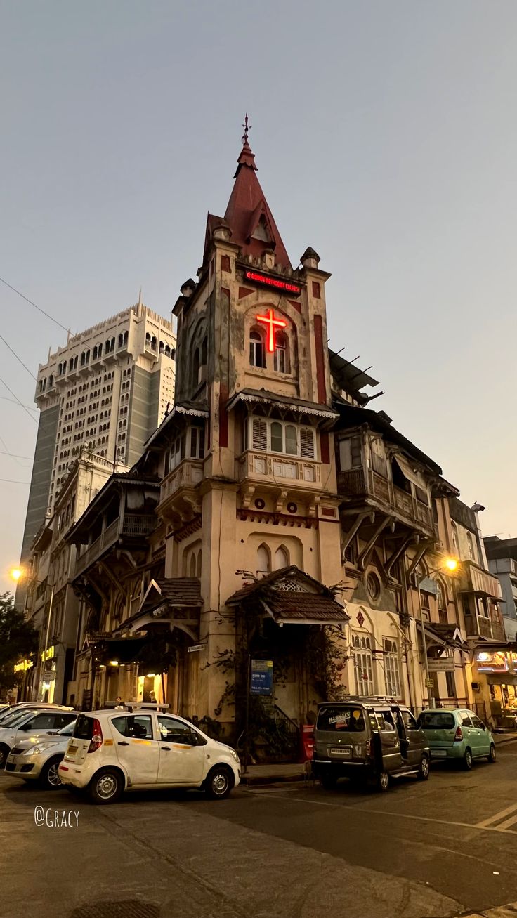 an old building with cars parked in front of it