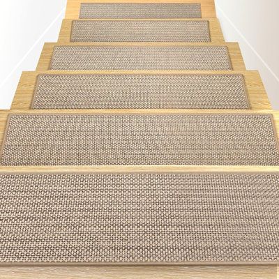 a set of beige carpeted stairs leading up to an open door with white walls