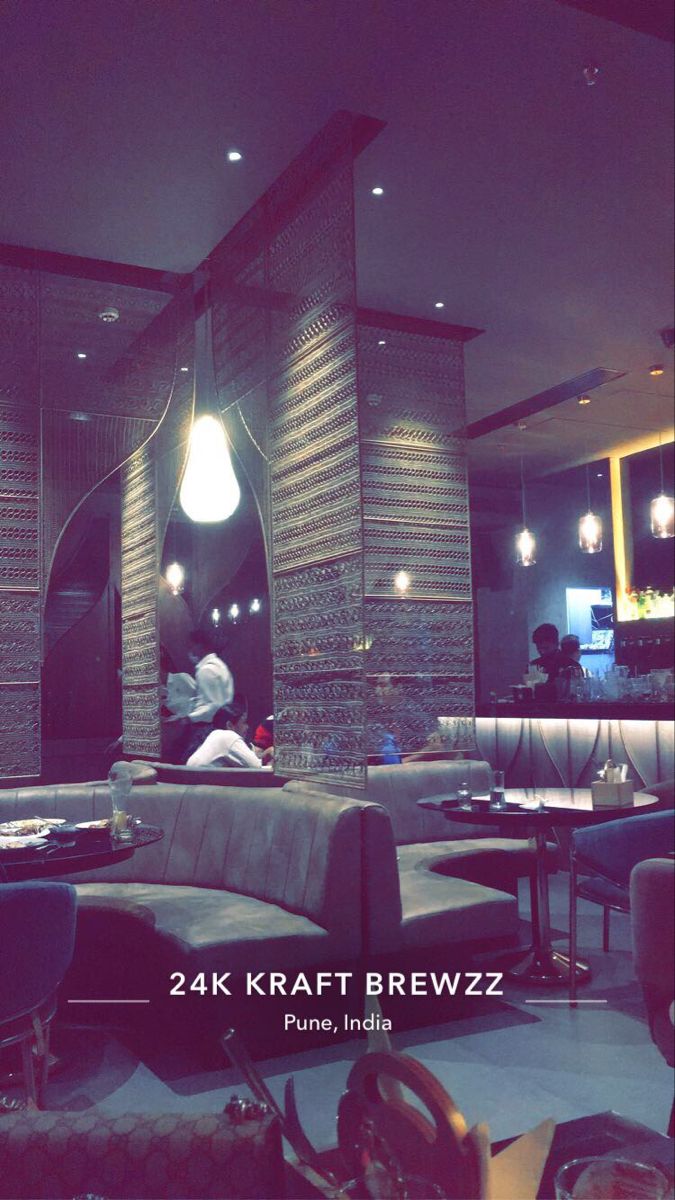 the interior of a restaurant with people sitting at tables and chairs in front of it