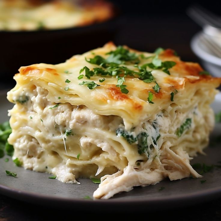 a close up of a plate of food with broccoli and chicken lasagna