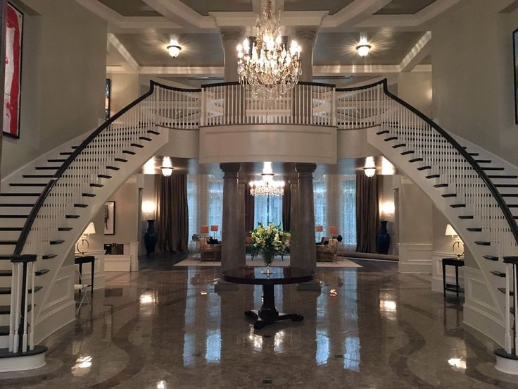 a large foyer with chandelier and marble floors