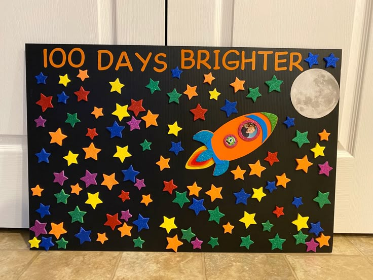 a sign that says, 100 days brighter with stars and a rocket ship on it