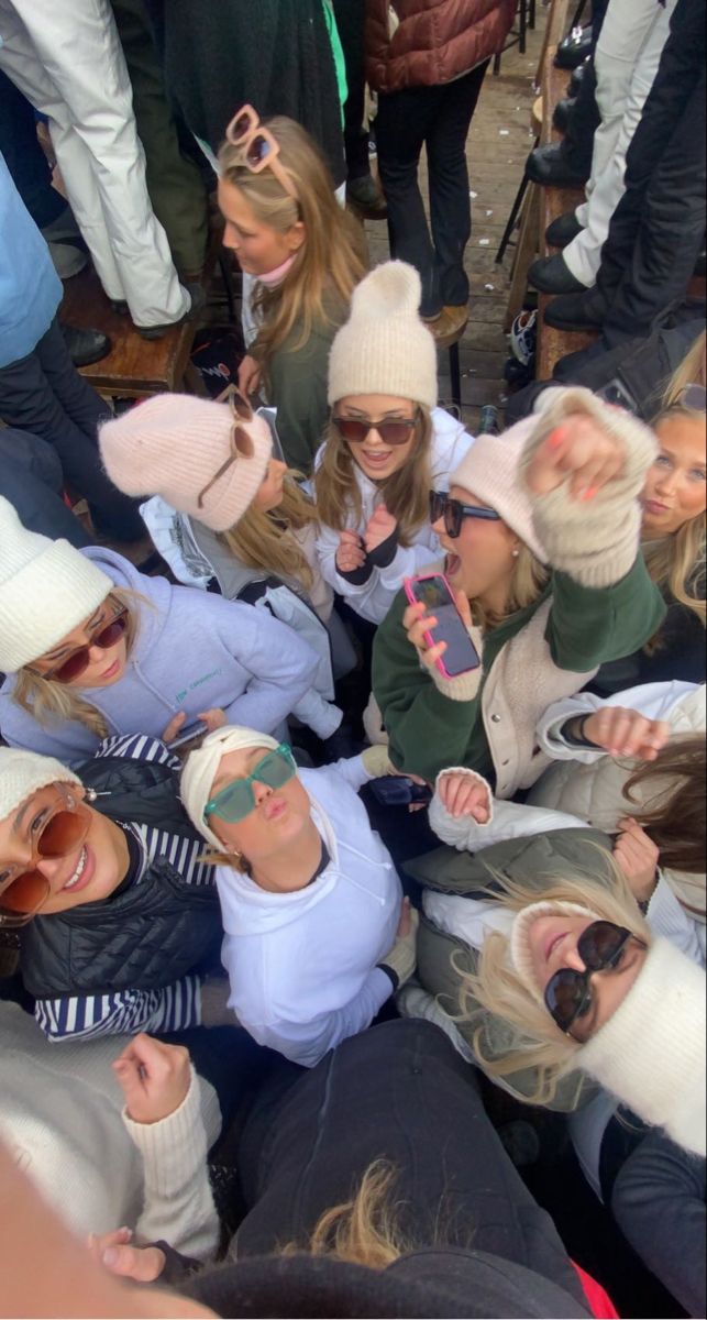 a group of people standing around each other in the middle of a circle with their hands together