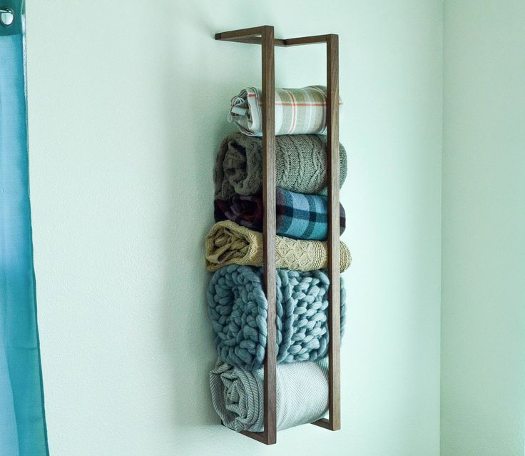 a rack with towels and blankets hanging on the wall