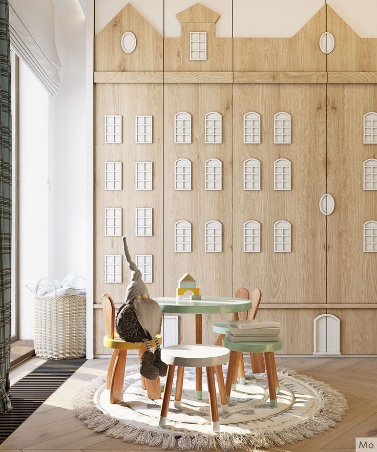 a living room filled with furniture next to a tall wooden wall covered in window panes