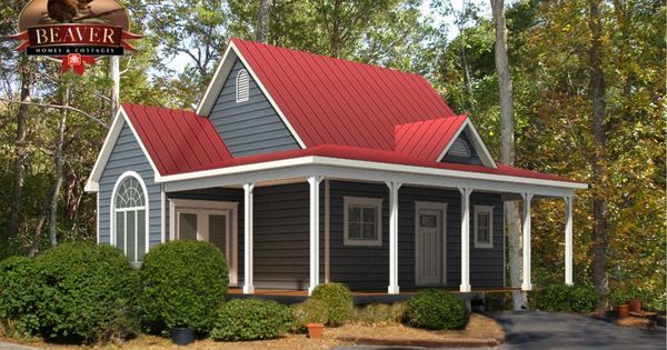 a small house with a red roof in the middle of some trees and bushes around it