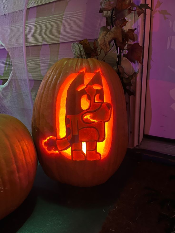 two carved pumpkins sitting next to each other