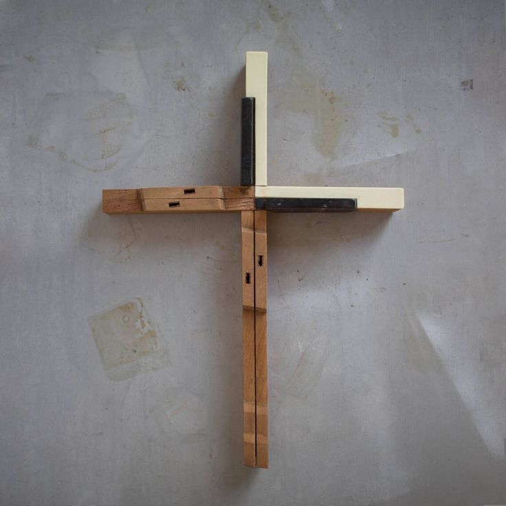 a wooden cross hanging on the wall