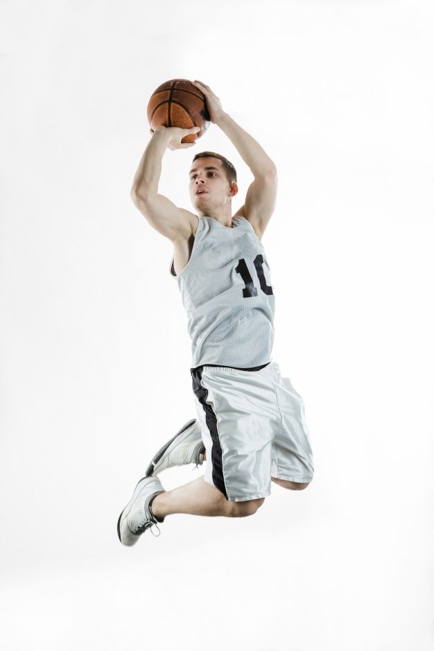 a young man is jumping in the air with a basketball